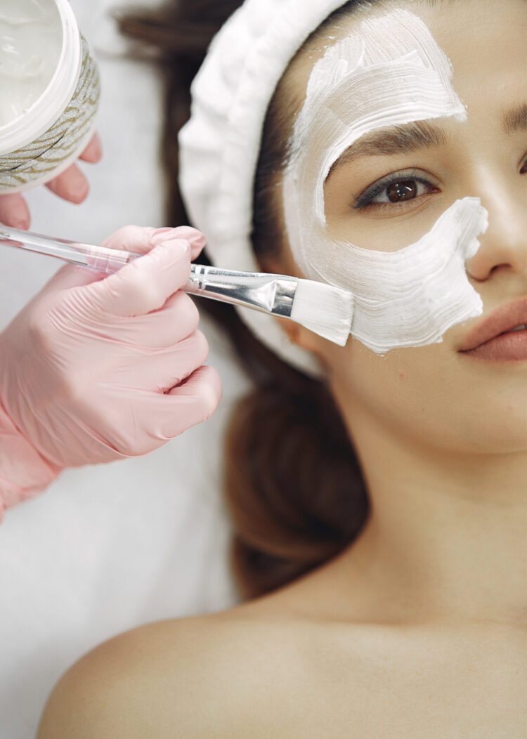 Cosmetologist treats client's skin. Woman with cosmetologist. Lady in a beauty studio.